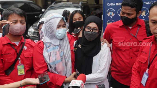 Ibunda Adam Deni memberikan keterangan pers sebelum menghadiri sidang perdana perkara dugaan penyebaran dokumen elektronik milik pribadi ke media sosial di Pengadilan Negeri Jakarta Utara, Senin (7/3/2022). [Suara.com/Angga Budhiyanto]