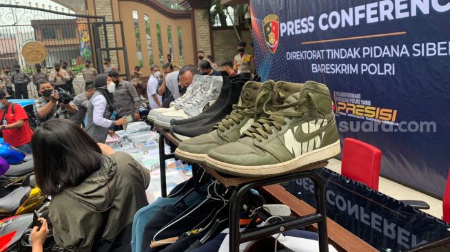 UTiga pasang sepatu merek Nike Air Jordan warna hijau, Air Dior warna putih, dan Balenciaga hitam milik Doni Salmanan ditampilkan saat rilis kasus penipuan binary Option di Mabes Polri, Jakarta Selatan, Selasa (15/3/2022).  [Suara.com/Adiyoga Priyambodo]