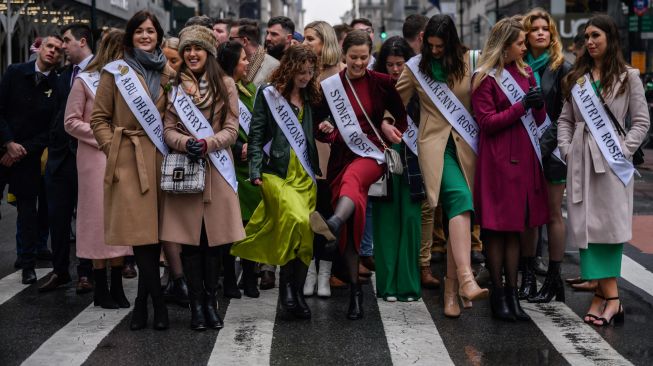 Para peserta Kontes Miss shamrock berbaris saat mengikuti parade perayaan Hari St. Patrick di New York, Amerika Serikat, Kamis (17/3/2022). [Ed JONES / AFP]