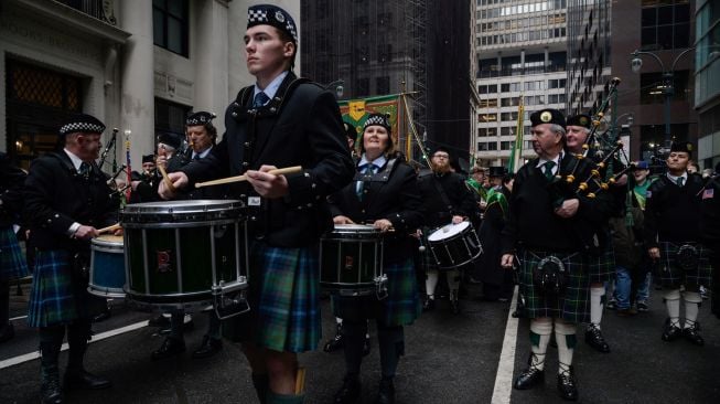 Para peserta berbaris saat parade perayaan Hari St. Patrick di New York, Amerika Serikat, Kamis (17/3/2022). [Ed JONES / AFP]
