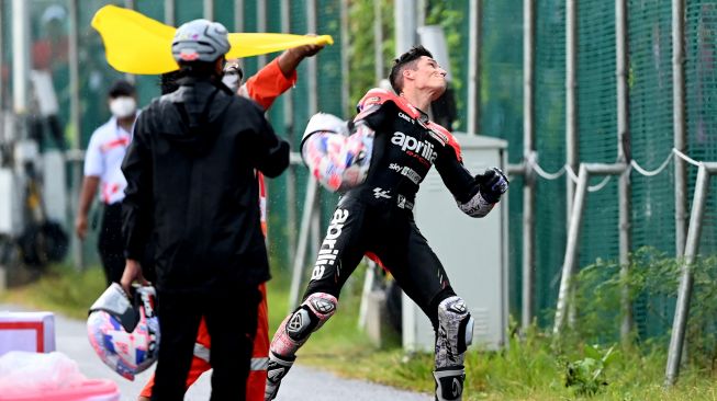 Pembalap Aprilia Racing Aleix Espargaro (kanan) melemparkan helmnya ke tribun penonton seusai balapan MotoGP seri Pertamina Grand Prix of Indonesia di Pertamina Mandalika International Street Circuit, Lombok Tengah, NTB, Minggu (20/3/2022).  ANTARA FOTO/Andika Wahyu