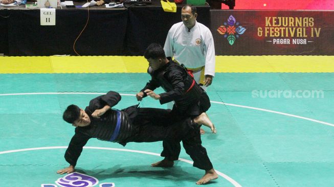 Pendekar silat Pagar Nusa saat bertanding dalam kejuaraan Nasional Keempat Sesi 2 Pagar Nusa di Padepokan Pencak Silat TMII, Jakarta, Minggu (27/3).   [Suara.com/Oke Atmaja]