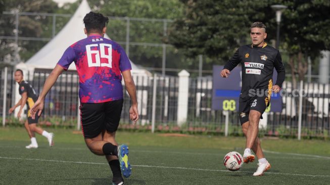 Pemain Selebritis FC Cristian Gonzáles menggiring bola saat mengikuti sesi latihan di Lapangan ABC, Kompleks Gelora Bung Karno, Jakarta, Senin (28/3/2022). [Suara.com/Angga Budhiyanto]