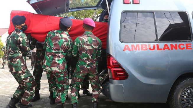 Prajurit TNI AL memasukan peti jenazah prajurit Marinir ke ambulan untuk diberangkatkan ke kampung halaman usai upacara pelepasan jenazah di Timika, Papua, Senin (28/3/2022). ANTARA FOTO /Sevianto Pakiding
