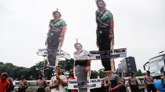 Massa membawa wayang besar bergambar Tan Paulin saat menggelar aksi demonstrasi di depan Gedung DPR RI, Jakarta Pusat, Kamis (31/3/2022). [Suara.com/Alfian Winanto]