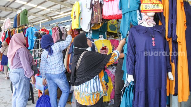 Warga berbelanja di Pasar Tanah Abang, Jakarta Pusat, Jumat (1/4/2022). [Suara.com/Alfian Winanto]