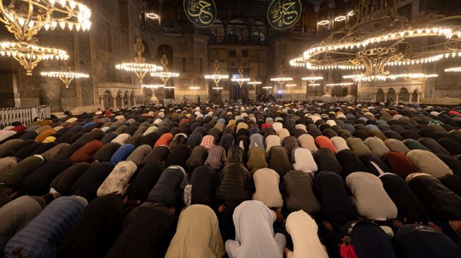 Umat Muslim melaksanakan ibadah shalat Tarawih di Masjid Hagia Sophia, Istanbul, Turki, Sabtu (1/4/2022). [Yasin AKGUL/AFP]