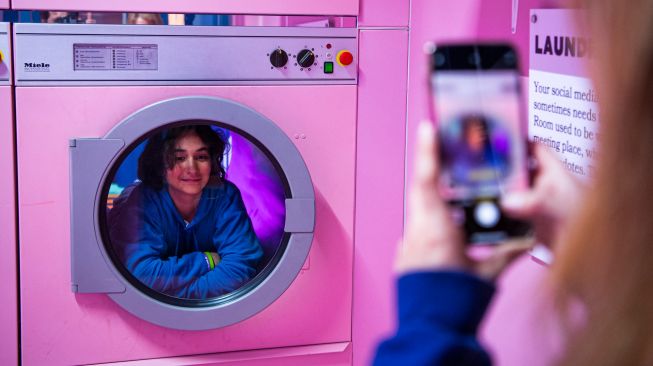 Orang-orang mengunjungi ruangan "Laundry" di dalam Youseum di Solna, Stockholm, Swedia, Senin (4/4/2022). [Jonathan NACKSTRAND / AFP]