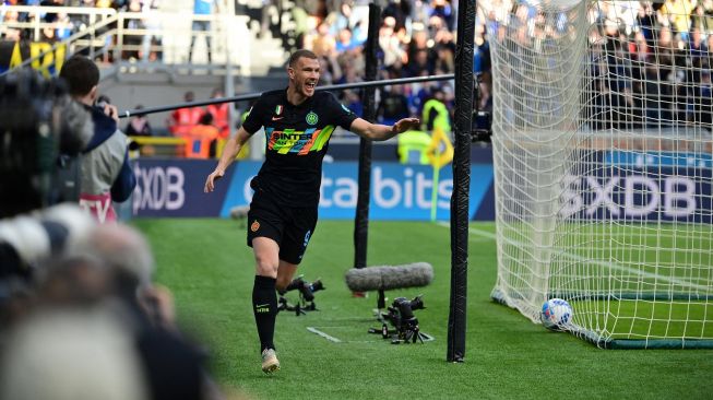 Pemain depan Inter Milan asal Edin Dzeko merayakan setelah mencetak gol selama pertandingan sepak bola Serie A Italia antara Inter Milan melawan Verona di stadion Giuseppe Meazza, Milan, Sabtu (9/4). 
MIGUEL MEDINA / AFP