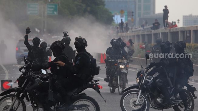 Polisi membubarkan massa aksi saat unjuk rasa di sekitar gedung DPR RI, Jakarta, Senin (11/4/2022). [Suara.com/Angga Budhiyanto]