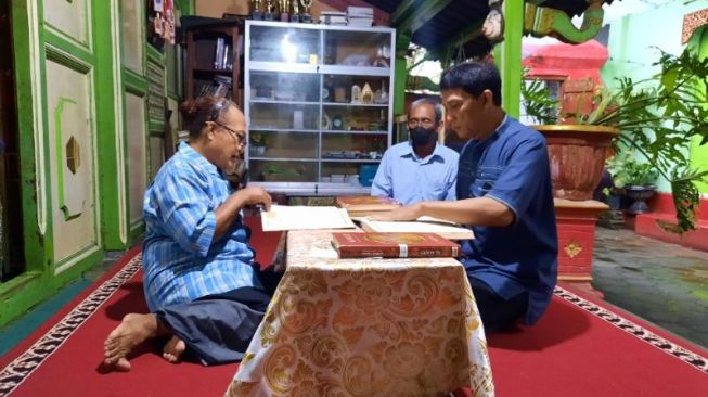 Transpuan asal Medan, Yeti tengah membaca Al-Quran menjelang berbuka puasa di Ponpes Waria Al-Fatah Yogyakarta, Minggu (24/4/2022). [Muhammad Ilham Baktora / SuaraJogja.id]