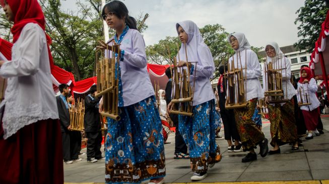 Pelajar memainkan alat musik tradisional angklung saat deklarasi Bandung Kota Angklung di Balai Kota, Bandung, Jawa Barat, Sabtu (21/5/2022). [ANTARA FOTO/Novrian Arbi/rwa]