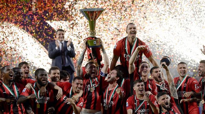 Para pemain AC Milan mengangkat trofi juara Liga Italia setelah AC Milan memenangkan pertandingan sepak bola Serie A Italia antara Sassuolo melawan AC Milan Minggu (22/5/2022) malam waktu setempat atau Senin (23/5/2022) dini hari .  [AFP Photo]