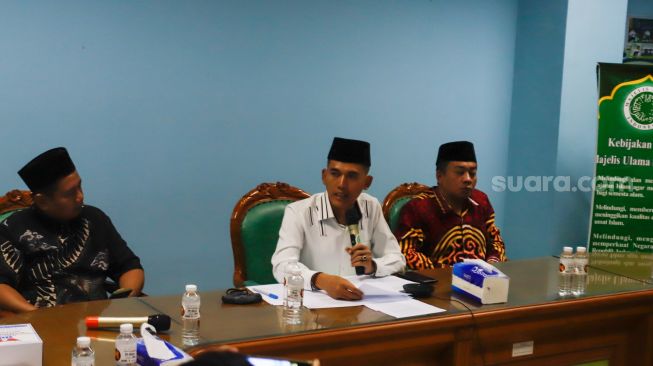 Ketua Komisi Fatwa MUI Asrorun Niam Soleh (tengah) saat memberikan keterangan pers terkait fatwa kurban ditengah wabah PMK di Gedung MUI Pusat, Jakarta Pusat, Selasa (31/5/2022). [Suara.com/Alfian Winanto]