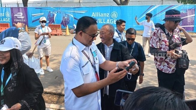 Gubernur DKI Jakarta Anies Baswedan di tengah inspeksi sirkuit Formula E, melayani foto dengan penggemar dari Tangerang sampai Kalimantan Utara [Suara.com/Fakhri Fuadi M].