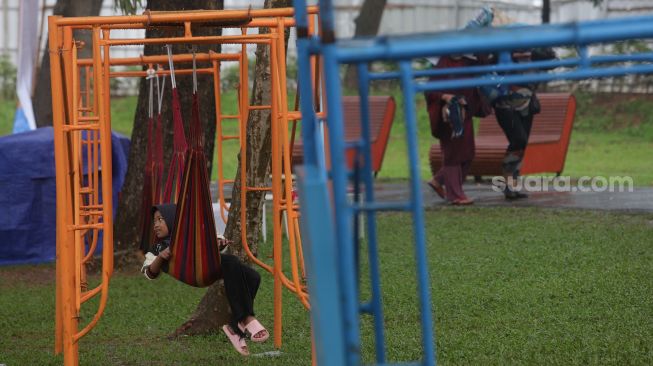 Seorang anak bermain pada instalasi yang dipasang dalam gelaran Festival Hari Lingkungan Hidup 2022 di Tebet Eco Park, Jakarta, Minggu (5/6/2022). [Suara.com/Angga Budhiyanto]