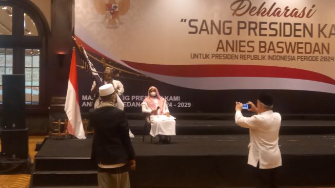 Seseorang tengah membawa bendera HTI untuk dicabut dari panggung acara deklarasi Anies Baswedan jadi Presiden 2024 di Jakarta, Rabu (8/6/2022). (Yosea Arga Pramudita).