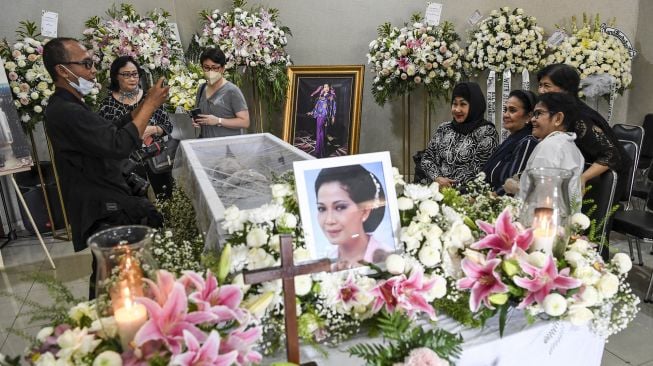 Sejumlah kerabat berfoto di sebelah peti jenazah aktris Rima Melati di Rumah Duka Rumah Sakit Pusat Angkatan Darat (RSPAD) Gatot Soebroto, Jakarta, Jumat (24/6/2022).  ANTARA FOTO/M Risyal Hidayat