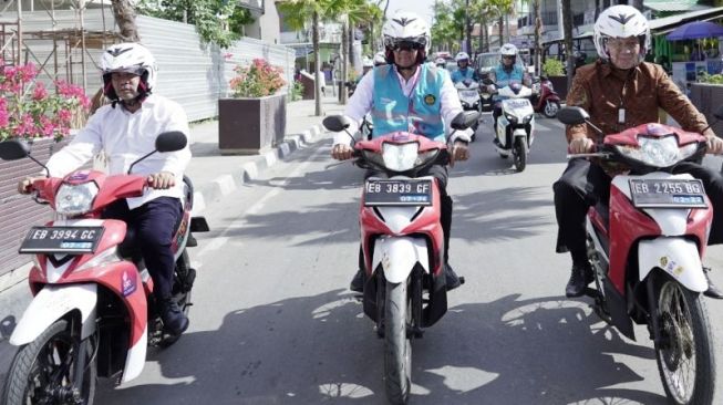 Menteri ESDM Arifin Tasrif (kanan), Direktur Utama PLN Darmawan Prasodjo (tengah) dan Gubernur NTT Viktor Bungtilu Laiskodat mengendarai motor listrik hasil konversi di Labuan Bajo, Manggarai Barat, NTT, Jumat (24/6/2022). [Antara/PLN]