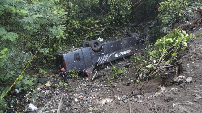 Polisi melakukan olah tempat kejadian perkara kecelakaan bus pariwisata yang masuk jurang di Kampung Cirendeu, Desa Manggungsari, Kecamatan Rajapolah, Kabupaten Tasikmalaya, Jawa Barat, Sabtu (25/6/2022).  ANTARA FOTO/Humas Polres Tasikmalaya Kota