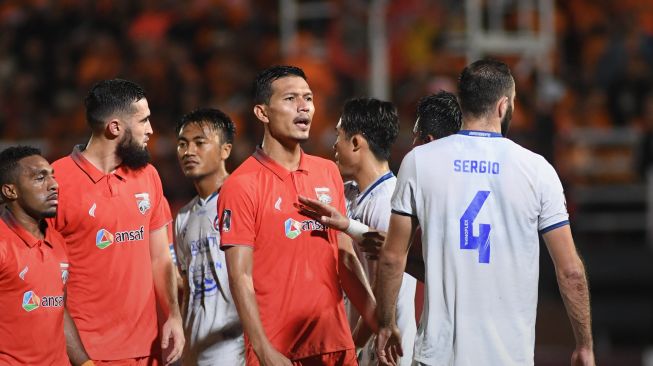 Bek Borneo FC, Agung Prasetyo (tengah) berdebat dengan beberapa pemain Arema FC usai melakukan tendangan kungfu ke Gian Zola. [Laman resmi Borneo FC]