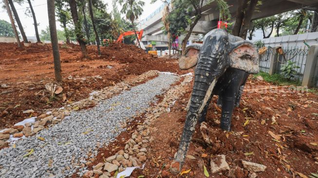 Pekerja menyelesaikan proyek revitalisasi Taman Martha Tiahahu di kawasan Blok M, Jakarta Selatan, Selasa (19/7/2022). [Suara.com/Alfian Winanto]