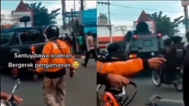 Pria berbaju Shopee Food jadi sorotan karena barang bawaannya saat pengaturan lalu lintas (Instagram)