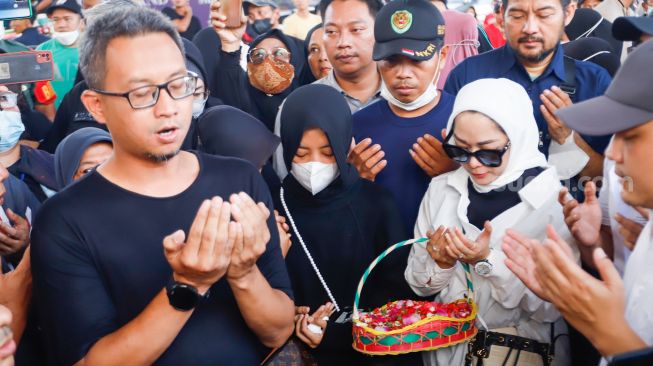 Keluarga korban dan warga doa bersama sebelum aksi tabur bunga di Jalan Transyogi Cibubur, Bekasi, Jawa Barat, Rabu (20/7/2022). [Suara.com/Alfian Winanto]