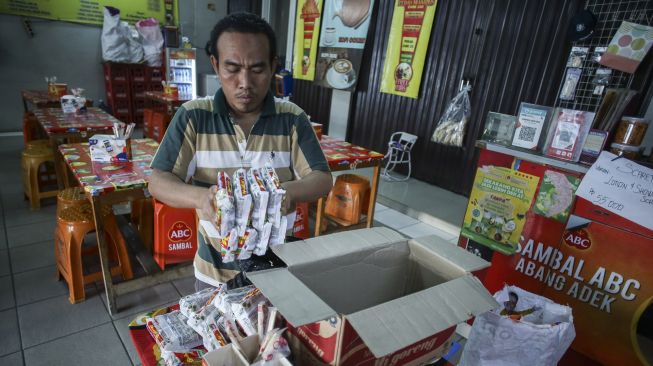 Pekerja menyiapkan mi instan untuk pembeli di Warung Abang Adek, Jakarta, Kamis (21/7/2022). ANTARA FOTO/Rivan Awal Lingga