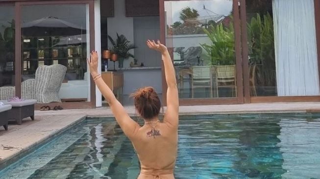 Pose seksi Wulan Guritno pakai bikini di kolam renang. [capture Instagram @wulanguritno] 