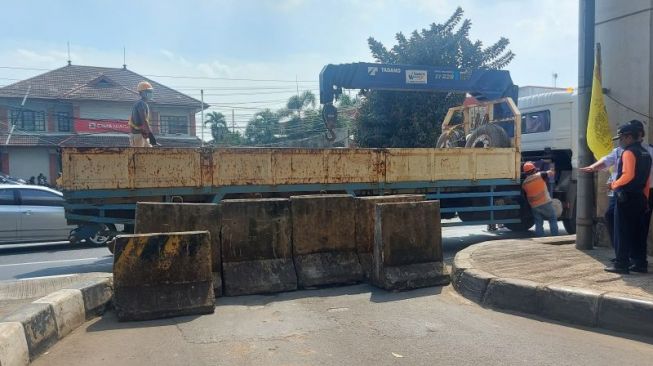 Petugas menutup akses Jembatan Kapin di Jalan Laksamana Malahayati, Duren Sawit, Jakarta, Kamis (28/7/2022). [ANTARA/Yogi Rachman]