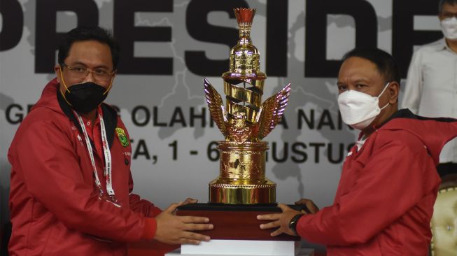 Menteri Pemuda dan Olahraga Zainudin Amali (kanan) menyerahkan trofi Piala Presiden kepada Ketua Umum PP PBSI Agung Firman Sampurna (kiri) saat membuka kejuaraan bulu tangkis Piala Presiden 2022 di GOR Nanggala, Cijantung, Jakarta, Senin (1/8/2022). [ANTARA FOTO/Indrianto Eko Suwarso/rwa]