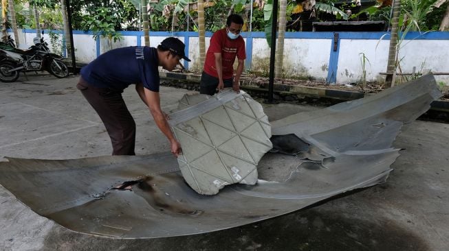 Petugas memperlihatkan lubang di pecahan badan Republik Rakyat Tiongkok (RRT) di Lembaga Penerbangan dan Antariksa Nasional (LAPAN) Pontianak, Kalimantan Barat, Sabtu (6/8/2022). ANTARA FOTO/Jessica Helena Wuysang