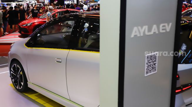 Pengunjung mengamati mobil listrik Daihatsu Ayla EV yang dipamerkan pada ajang pameran otomotif Gaikindo Indonesia International Auto Show (GIIAS) 2022 di Indonesia Convention Exhibition (ICE) BSD, Serpong, Tangerang, Banten, Sabtu (13/8/2022). [Suara.com/Alfian Winanto]