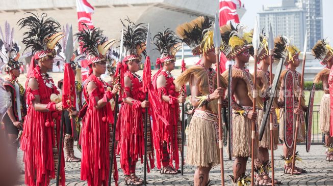 Sejumlah pasuka pengawal bendera mengenakan baju adat ketika Parade Kirab Bendera Pusaka dari Monas menuju Istana Merdeka di Jakarta Pusat, Rabu (17/8/2022). [Suara.com/Alfian Winanto]