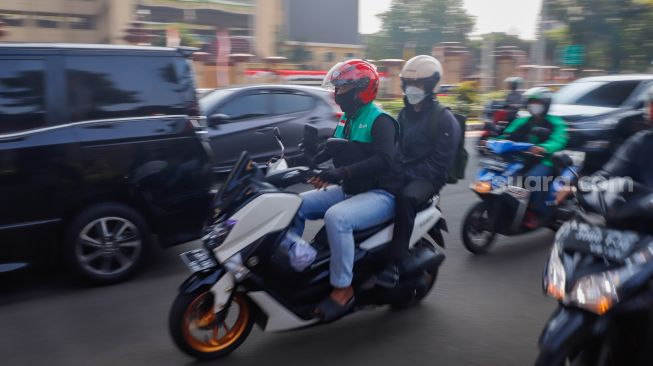 Pengemudi ojek online membawa penumpang di Jalan Trunojoyo Jakarta Selatan, Kamis (18/8/2022). [Suara.com/Alfian Winanto]