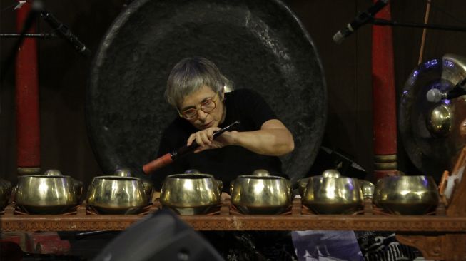 Seniman asal Prancis Marie-Pierre Faurite memainkan alat musik gamelan saat pertunjukan tari dan gamelan bertajuk "Legenda Godogan Kungkum Kodok" di Surabaya, Jawa Timur, Rabu (24/8/2022). [ANTARA FOTO/Moch Asim/aww]