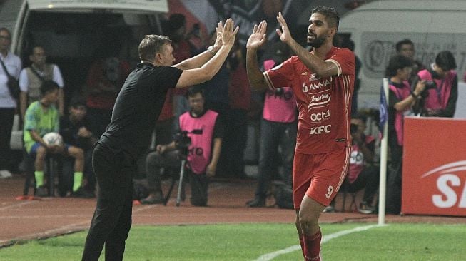 Pesepak bola Persija Jakarta Abdulla Yusuf (kanan) melakukan selebrasi bersama Pelatih Thomas Doll (kiri) usai menjebol gawang Persita Tangerang pada lanjutan Liga 1 di Stadion Patriot Chandrabhaga, Bekasi, Jawa Barat, Rabu (24/8/2022). [ANTARA FOTO/ Fakhri Hermansyah/aww]