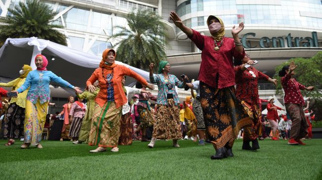 Sejumlah perempuan dari berbagai komunitas wanita berkebaya menari dan berdansa dalam acara Kebaya Berdansa di Tribeca Park, Jakarta, Sabtu (27/8/2022).  ANTARA FOTO/Indrianto Eko Suwarso