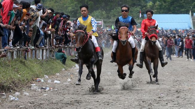 Para joki memacu kudanya pada tradisi pacuan kuda tradisional Gayo di lapangan HM Hasan, Blang Bebangka, Aceh Tengah, Aceh, Sabtu (27/8/2022). [ANTARA FOTO/Irwansyah Putra/tom]