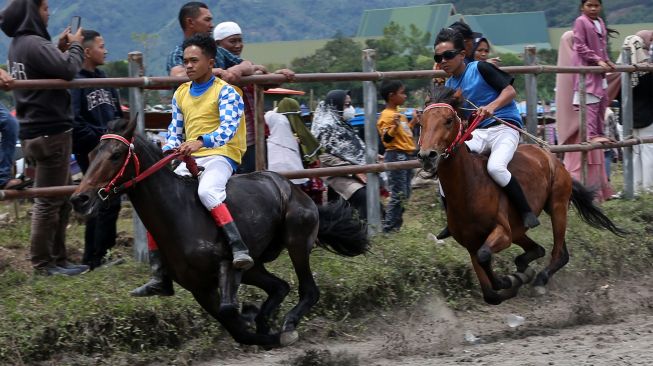 Para joki memacu kudanya pada tradisi pacuan kuda tradisional Gayo di lapangan HM Hasan, Blang Bebangka, Aceh Tengah, Aceh, Sabtu (27/8/2022). [ANTARA FOTO/Irwansyah Putra/tom]