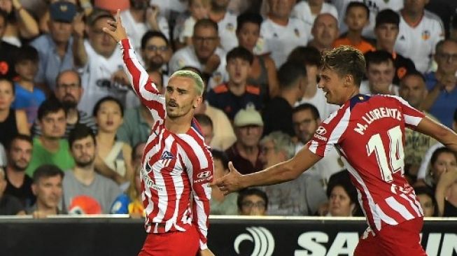 Pemain depan Atletico Madrid Antoine Griezmann (kiri) merayakan golnya pada pertandingan sepak bola Liga Spanyol antara Valencia CF dan Atletico Madrid di stadion Mestalla di Valencia pada 29 Agustus 2022. JOSE JORDAN / AFP