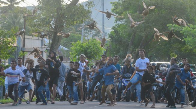 Peserta menerbangkan itik mereka saat digelarnya Pacu Itik di Gelanggang Aua Kuniang, Kota Payakumbuh, Sumatera Barat, Sabtu (3/9/2022). [ANTARA FOTO/Iggoy el Fitra/wsj]
