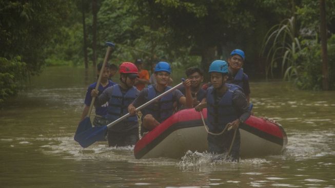 ejumlah relawan mengevakuasi warga saat terjadi banjir di Desa Haliau, Kabupaten Hulu Sungai Tengah, Kalimantan Selatan, Jumat (9/9/2022). [ANTARA FOTO/Bayu Pratama S/aww].