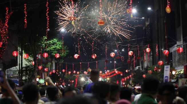 Warga menyaksikan pesta kembang api di kawasan Wisata Pecinan Kembang Jepun, Surabaya, Jawa Timur, Sabtu (10/9/2022). [ANTARA FOTO/Didik Suhartono/rwa]