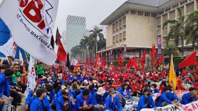 Buruh dari aliansi Gerakan Buruh Bersama Rakyat (Gebrak) dan Kongres Aliansi Serikat Buruh Indonesia (KASBI), serta mahasiswa Esa Unggul memblokir sebagian jalan MH Thamrin, Jakarta Pusat, Selasa (13/9/2022) siang. (ANTARA/Ricky Prayoga)