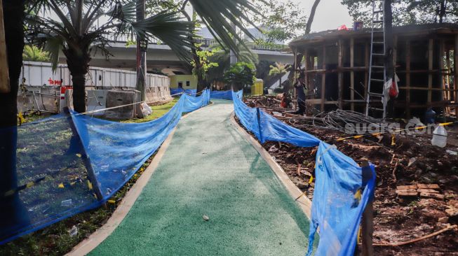 Pekerja menyelesaikan pembangunan jalur sepeda di kawasan Semanggi, Jakarta Pusat, Sabtu (24/9/2022). [Suara.com/Alfian Winanto]