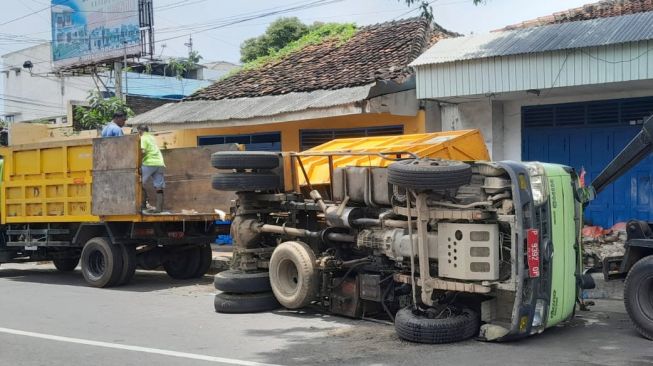Truk Plat Merah Muat Sampah Terguling di Jalan MH Thamrin Banyuwangi