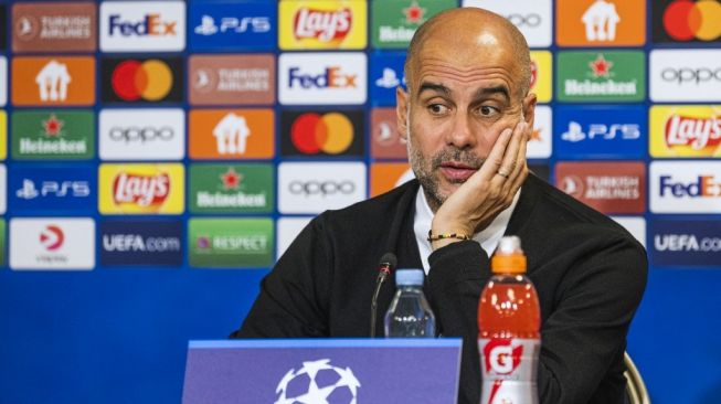 Manajer Manchester City, Pep Guardiola menghadiri konferensi pers jelang laga Liga Champions kontra FC Copenhagen di Stadion Parken. [Jonathan NACKSTRAND / AFP]