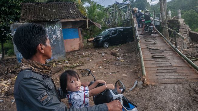 Sejumlah pengendara roda dua antre saat akan melintasi jembatan sementara di Sukajaya, Lebak, Banten, Selasa (11/10/2022).  ANTARA FOTO/Muhammad Bagus Khoirunas